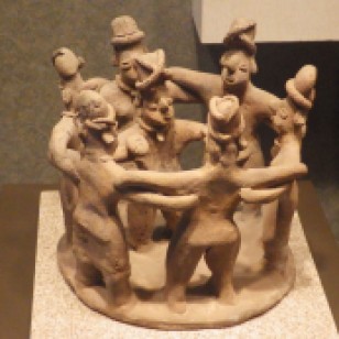 The shaman in the centre is holding a peyote.